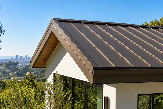 AI-generated illustration: matte bronze standing-seam metal roof on a modern home viewed from a low corner