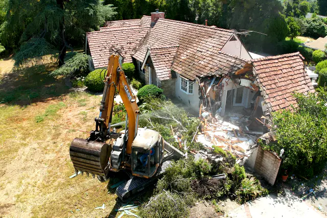 Excavator demolishing an old house on the Northridge SB 9 lot
