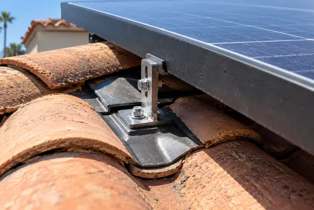AI-generated illustration: flashed solar mounting hardware above a clay-tile roof