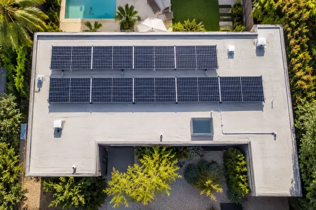 AI-generated illustration: solar array set back from the parapet on a flat residential roof